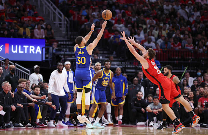 Warriors guard Stephen Curry shoots the ball as Houston Rockets center Alperen Sengun defends during the fourth quarter at Toyota Center.